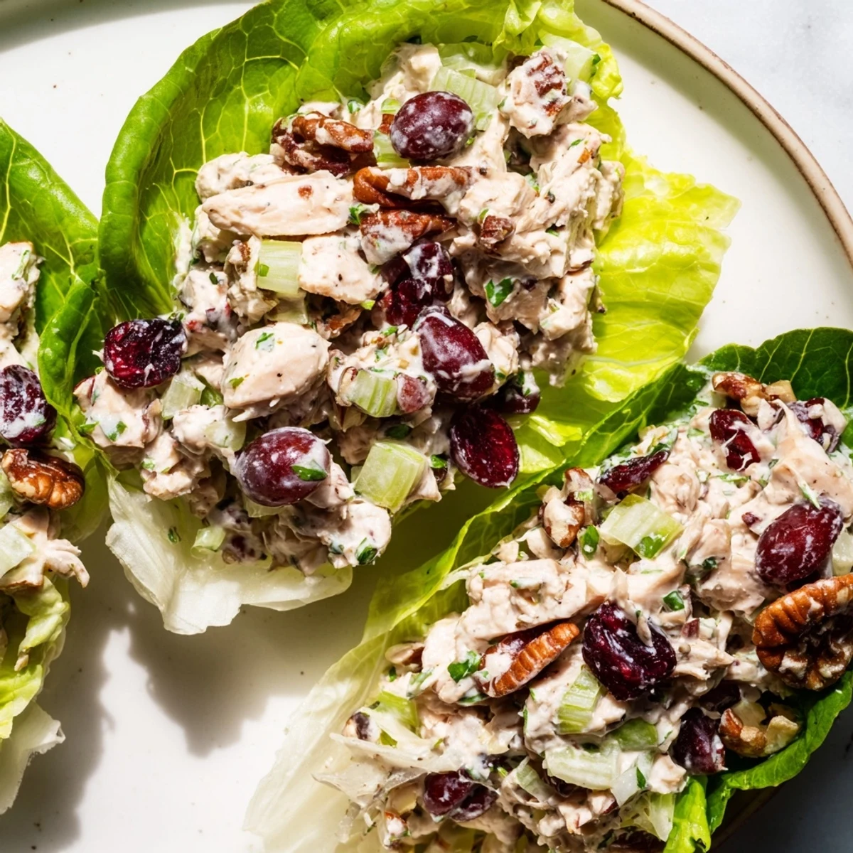 Festive Chicken Salad Cups, a colorful appetizer featuring sweet grapes and crunchy pecans.