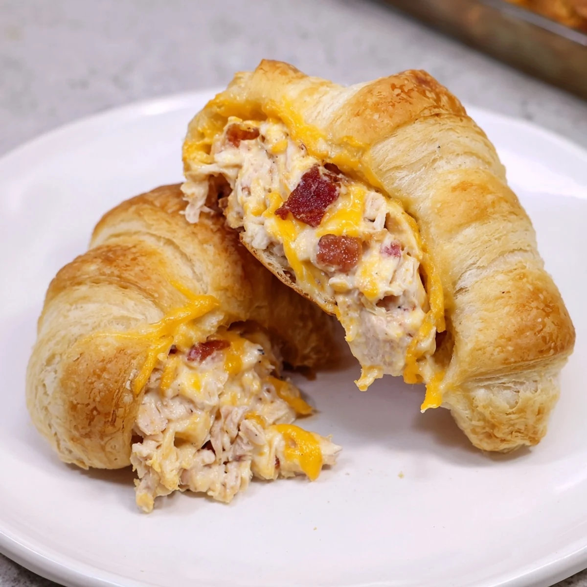 Golden-brown Cheesy Chicken and Bacon Crescent Rolls, filled with melty cheese and crispy bacon inside.