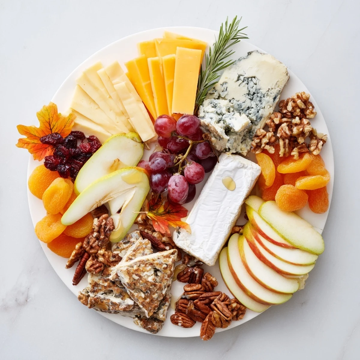 This festive Autumn Leaf Cheese Platter displays creamy brie next to a sharp cheddar, and grapes.