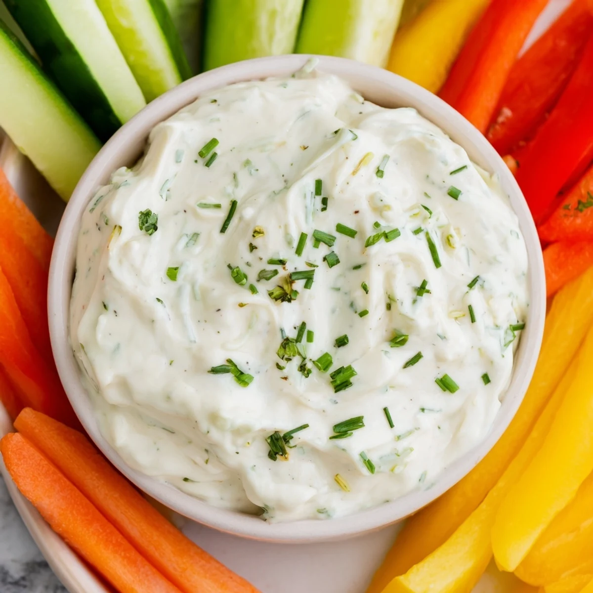 Fresh Kids Dip is a delightful cream cheese and ranch dip served with colorful carrot, celery and pepper sticks.