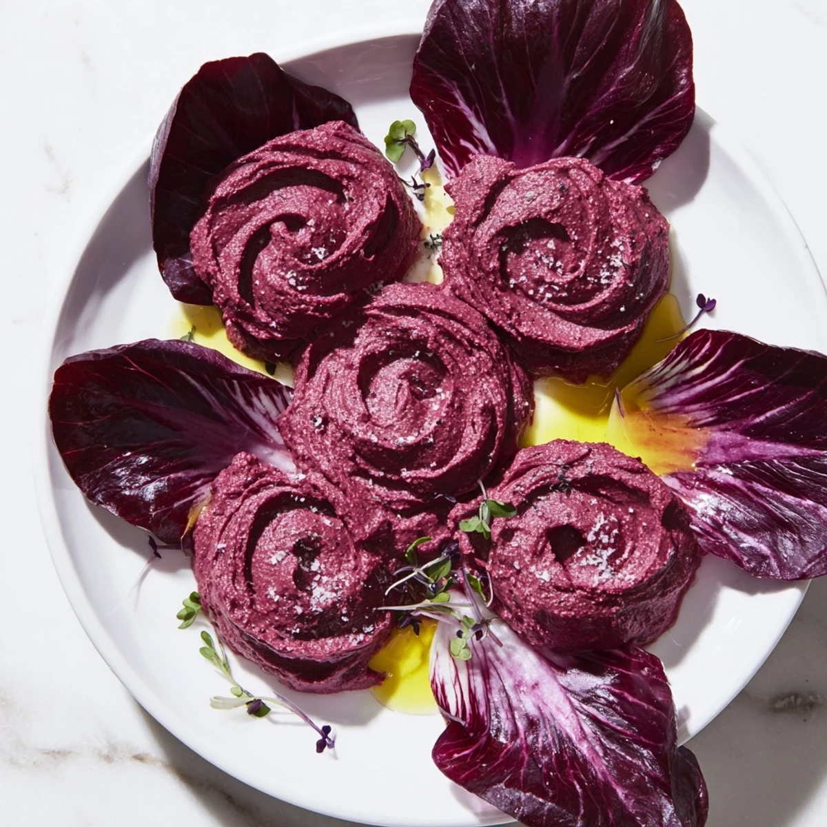 Creamy, dark red beet hummus shapes a stunning The Velvet Rose, offering earthy flavors in appetizer form.
