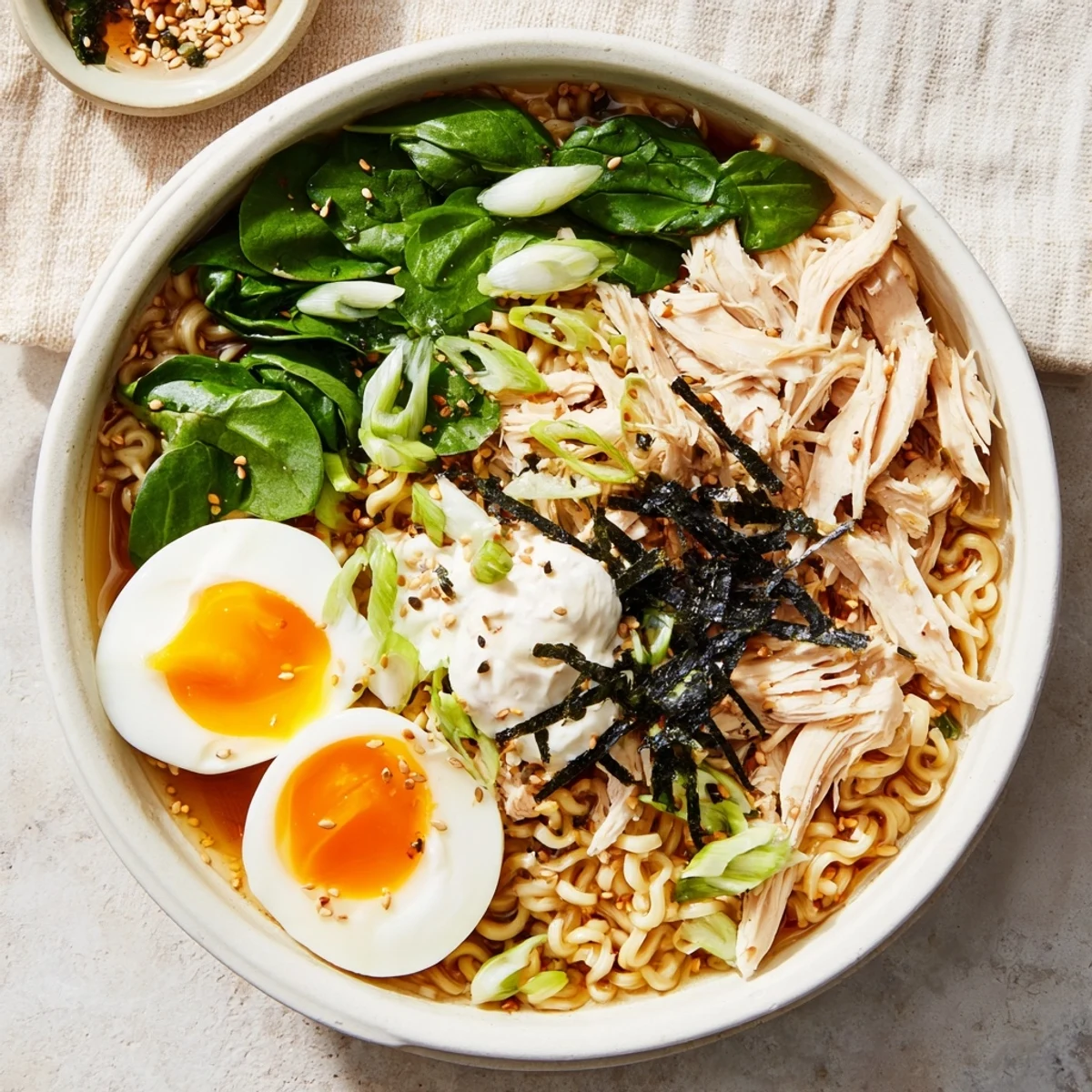 Steaming bowl of Chicken Ramen with tender chicken, spinach, and a swirl of rich Kewpie mayo.