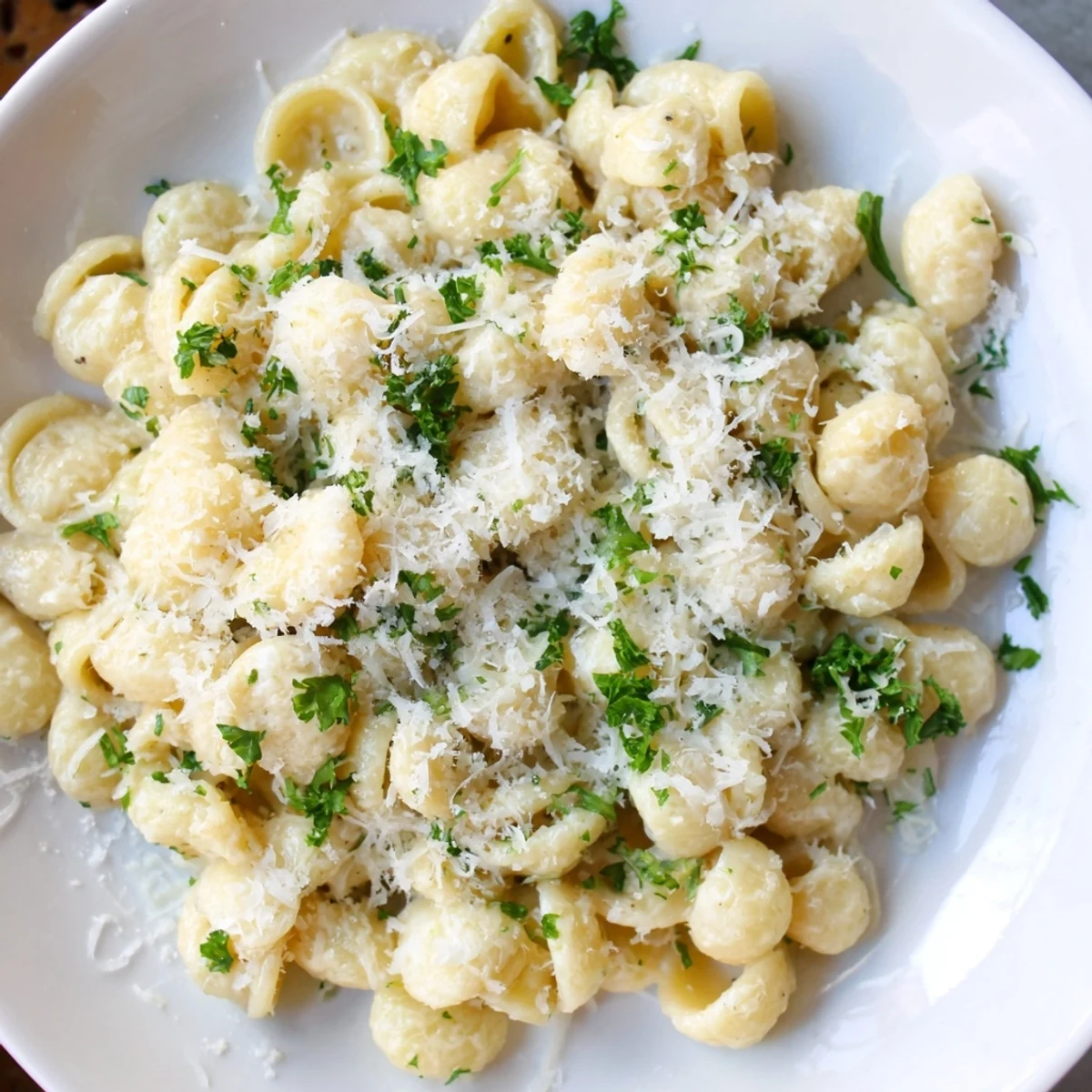 Golden, creamy 15-Minute Garlic Parmesan Pasta, ready to serve with extra Parmesan snowed on top.