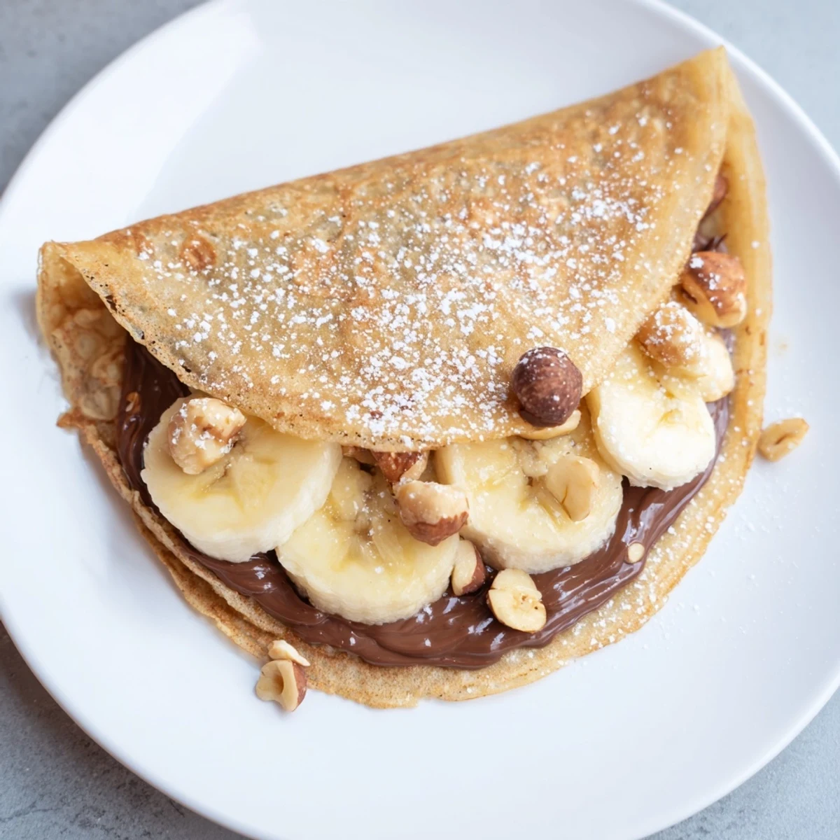 Crispy-edged Banana Nutella Wrap ready to eat, featuring a folded tortilla loaded with Nutella and bananas.