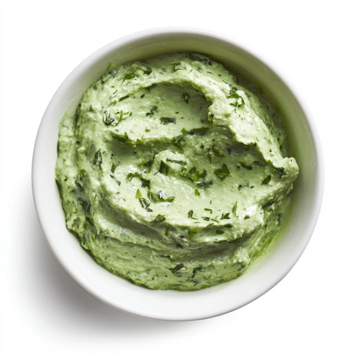 A bowl of refreshing Green Goddess Dip, ready to be scooped up with colorful veggies.