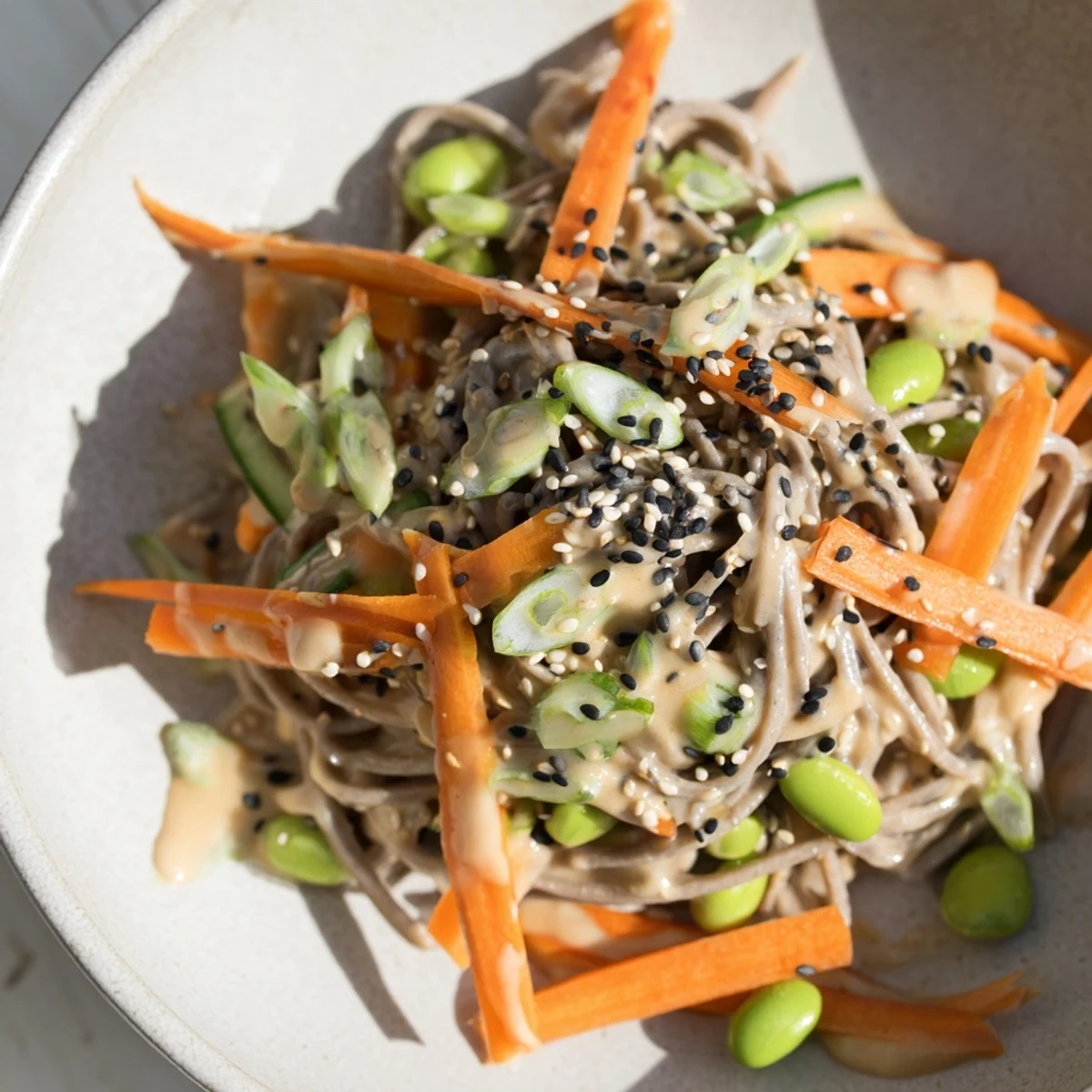 Delicious Asian Sesame Noodle Salad, featuring soba noodles with edamame, and a light sesame dressing.