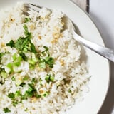 Fluffy jasmine rice garlic side dish topped with fresh cilantro, steaming warmly on a rustic plate.