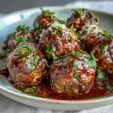 Juicy slow cooker meatballs in rich tomato sauce, perfect for a housewarming party appetizer or main dish.  