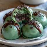 Vibrant green Oreo truffle balls coated in creamy white chocolate for St. Patrick's Day celebrations.