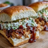 Slow-cooked chicken with zesty ranch and au jus, topped with crisp coleslaw on buttery slider buns—perfect for game day.  