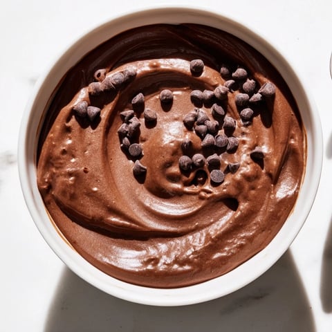 Creamy gluten-free brownie batter dip, swirled with chocolate chips, ready for dipping and enjoying.