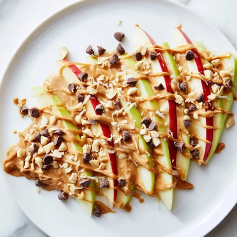 Crisp apple slices covered in peanut butter, making these easy Peanut Butter Apple Nachos.
