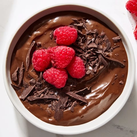 Silky smooth Chocolate Avocado Mousse with fresh berries piled high, a decadent dessert.