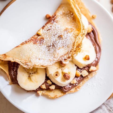 Golden-brown Banana Nutella Wrap, filled with melting chocolate and sweet banana slices, a rich dessert.