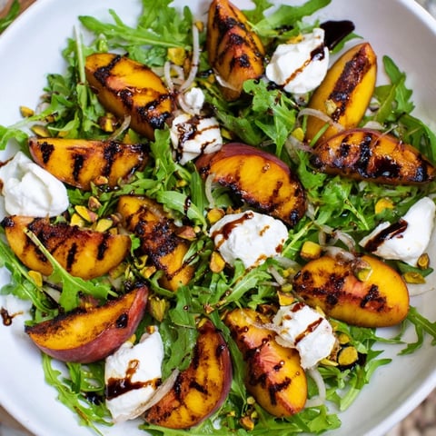 Grilled Peach Salad with charred peaches, creamy burrata, and a balsamic glaze, ready to eat.