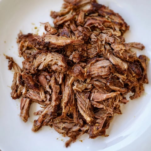 Tender Omani Shuwa, slow-cooked lamb shoulder wrapped in fragrant banana leaves, ready to be served.