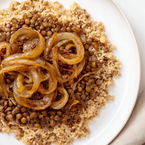 Golden caramelized onions crown a bowl of fragrant Lebanese Mjadra, lentils and rice.