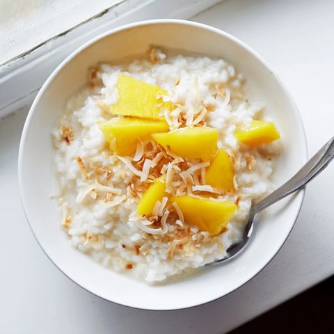Steamed coconut rice sweetens the palate with creamy jasmine rice and warm vanilla, topped with toasted flakes and fresh mango.