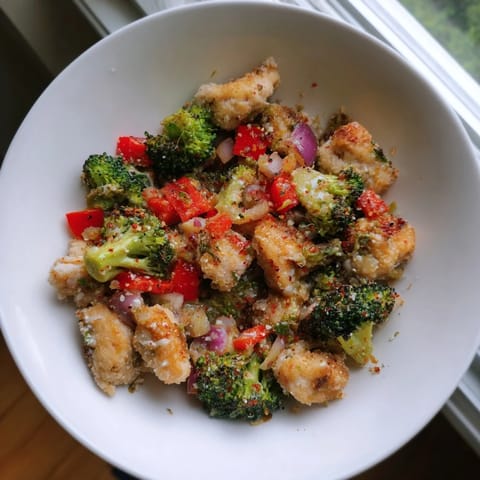 Sheet pan of Garlic Parmesan Chicken Bites, with tender chicken and broccoli, perfect for a quick dinner.