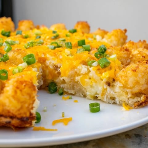 A family-friendly Tater Tot Frittata, showcasing a cheesy, egg-filled bake served hot from the oven.