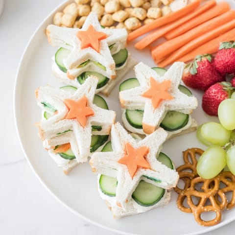 Fresh grapes and carrot sticks surround charming Beach Day Starfish snacks perfect for summer.