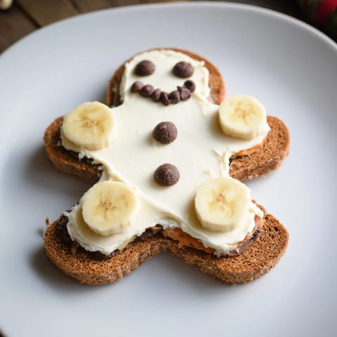 Adorable gingerbread man sandwich cutouts with raisin eyes and apple smiles, ready to eat.