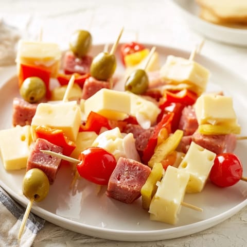 Golden cheese and meat cubes on the Savory Skewers, arranged with tangy pickles for a perfect bite.