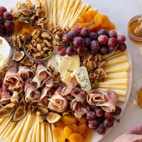 This Plateau des Rois Mages Gourmand features perfectly arranged cheeses, cured meats, and dried fruits for sharing.