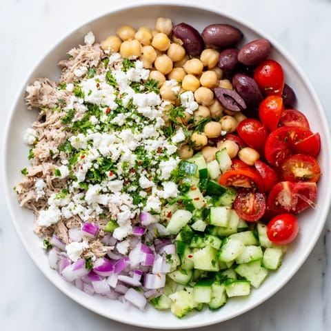 Freshly tossed Tuna Chickpea Salad, showcasing tender tuna chunks and a zesty, flavorful dressing.