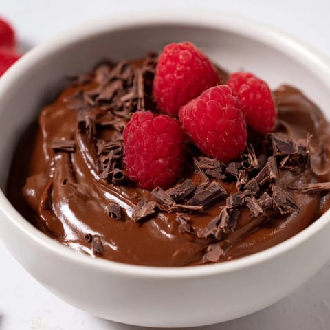 A close-up of creamy, dark Chocolate Avocado Mousse, a healthy vegan treat with cocoa.