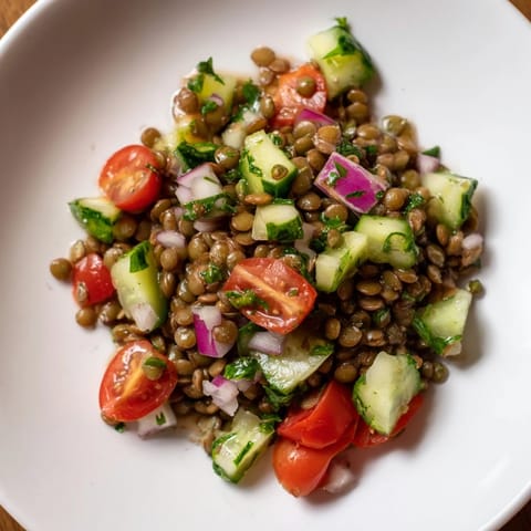 Freshly tossed Lentil Salad, a vibrant mix of lentils and vegetables, perfect for a light, healthy meal.