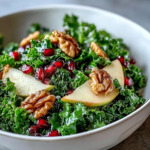A vibrant, two-serving Kale and Pomegranate Bowl ready to eat, garnished with nuts and bright fruit for a healthy vegetarian meal.