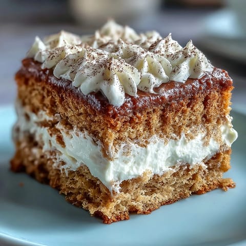 A close-up of Fluffy Hojicha Cake showcases a light, airy crumb, delicately dusted with hojicha powder for a rustic look.