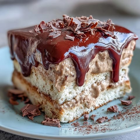 Close-up of the Japanese-inspired Hojicha Butter Cream Cake, displaying moist sponge layers and a rich dark chocolate ganache drip.