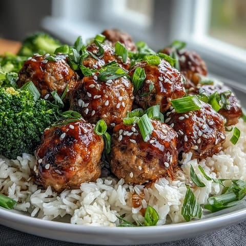 Steamed broccoli florets and glazed Honey Garlic Turkey Meatballs served hot over jasmine rice for a family-style bowl.