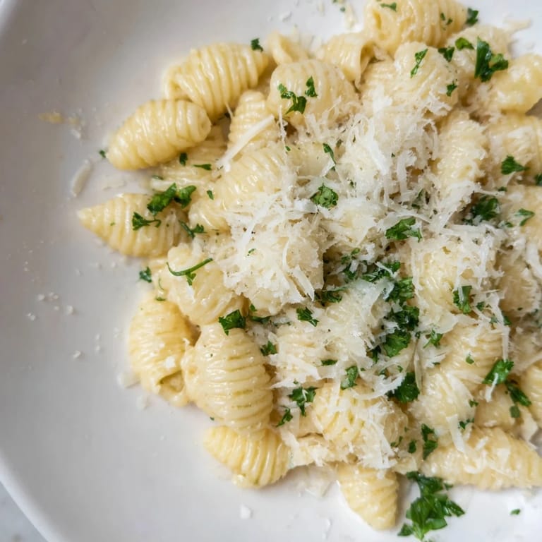 A steaming bowl of flavorful 15-Minute Garlic Parmesan Pasta, featuring a rich, cheesy sauce.