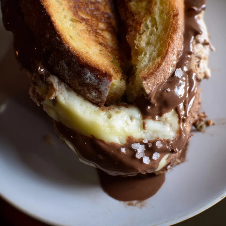 Savory and sweet: A delicious Nutella Grilled Cheese with Chicken, ready to eat, cut in half.