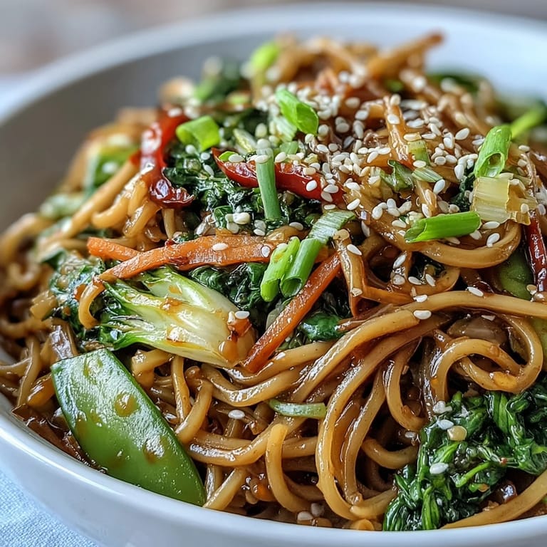 A colorful, low-carb shirataki noodle bowl served with snow peas, carrots, and toasted sesame seeds.  