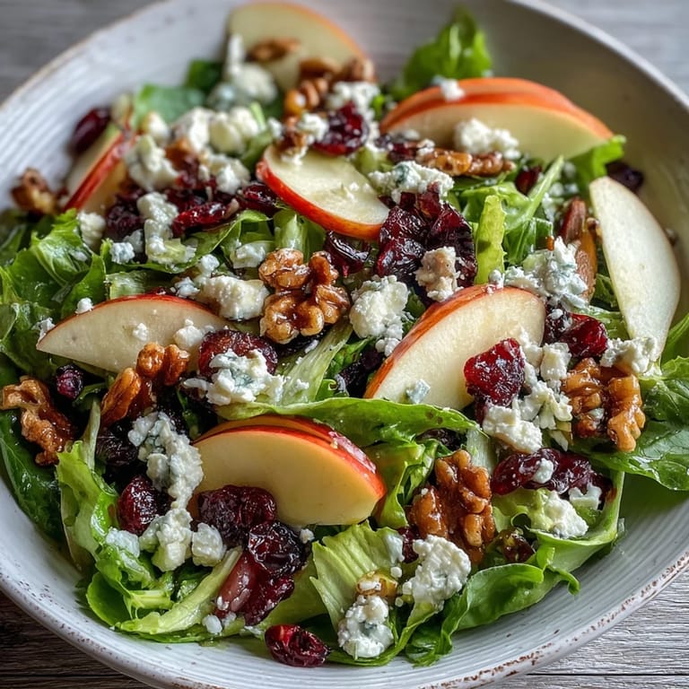 Ready-to-eat Mixed Greens and Apple Bowl, featuring red onion and optional dried cranberries, served as a light vegetarian lunch.