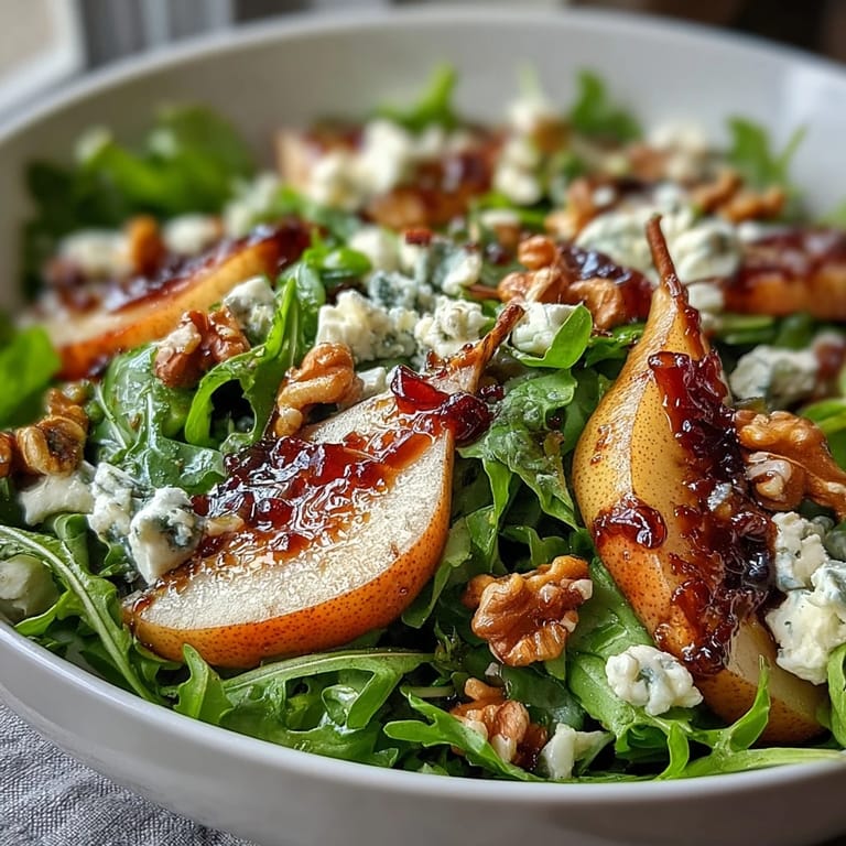 A vibrant Arugula and Pear Bowl tossed with honey-Dijon dressing, ready to serve as a refreshing vegetarian salad or light main dish.