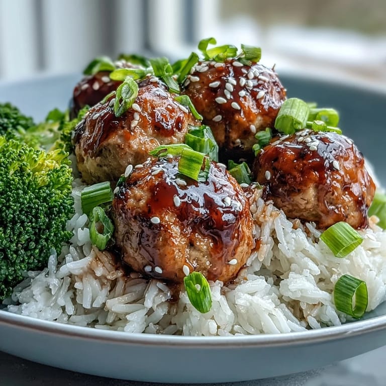 Sesame-garnished Honey Garlic Turkey Meatball Bowls feature tender turkey, sweet–savory sauce, and crisp veggies for a wholesome meal.