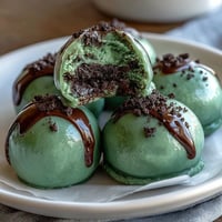 Vibrant green Oreo truffle balls coated in creamy white chocolate for St. Patrick's Day celebrations.