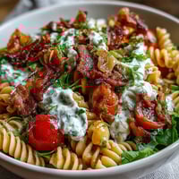 Fresh BLT pasta salad with bacon and avocado, tossed with cherry tomatoes and crisp romaine lettuce in a creamy dressing.