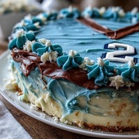 Festive sports jersey graduation cake decorated with blue fondant and personalized number 23, celebrating a young athlete's big milestone.