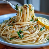 Creamy lemon-butter pasta with parmesan and fresh basil, a bright and zesty spring dish perfect for quick dinners.  